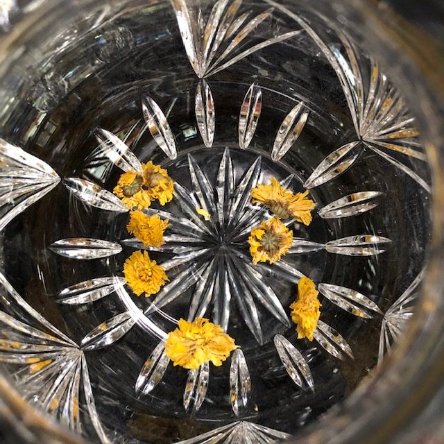 dried flowers in cut glass vase
